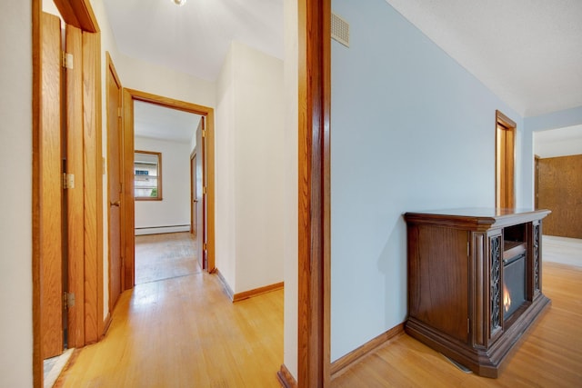 895 Humboldt Ave W, Saint Paul, MN 55118 - hallway with baseboard heating and light wood-style floors