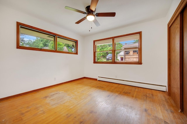 895 Humboldt Ave W, Saint Paul, MN 55118 - unfurnished bedroom with a baseboard radiator, light wood finished floors, a closet, and ceiling fan