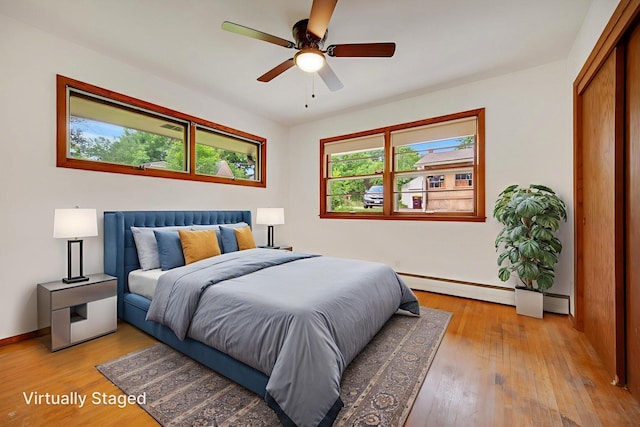 895 Humboldt Ave W, Saint Paul, MN 55118 - bedroom featuring light wood finished floors, ceiling fan, and a baseboard radiator