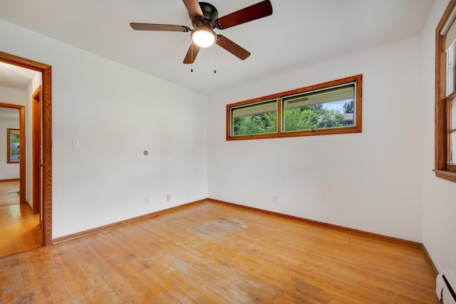 895 Humboldt Ave W, Saint Paul, MN 55118 - unfurnished room featuring light wood-style flooring, a ceiling fan, and a baseboard radiator