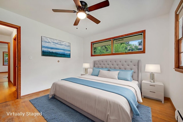 895 Humboldt Ave W, Saint Paul, MN 55118 - bedroom featuring light wood-type flooring, a baseboard heating unit, and a ceiling fan