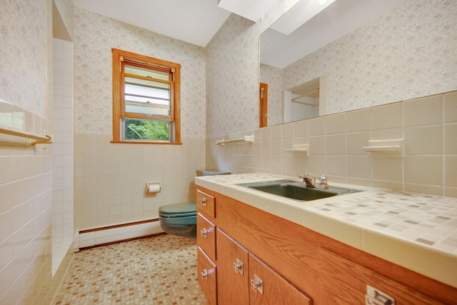 895 Humboldt Ave W, Saint Paul, MN 55118 - bathroom with wallpapered walls, a baseboard heating unit, tile walls, vanity, and a wainscoted wall