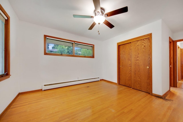 895 Humboldt Ave W, Saint Paul, MN 55118 - unfurnished bedroom with baseboard heating, light wood finished floors, a closet, and a ceiling fan