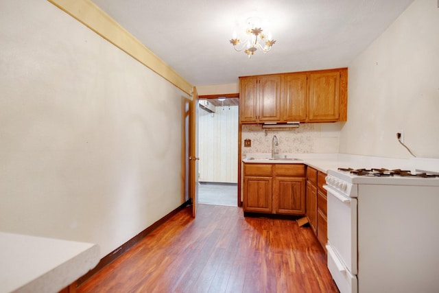 895 Humboldt Ave W, Saint Paul, MN 55118 - kitchen with gas range gas stove, dark wood-style floors, light countertops, brown cabinetry, and tasteful backsplash