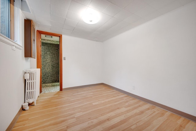 895 Humboldt Ave W, Saint Paul, MN 55118 - spare room with radiator heating unit and wood finished floors