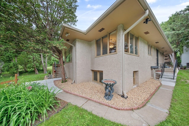 895 Humboldt Ave W, Saint Paul, MN 55118 - view of side of property featuring stucco siding and stairs