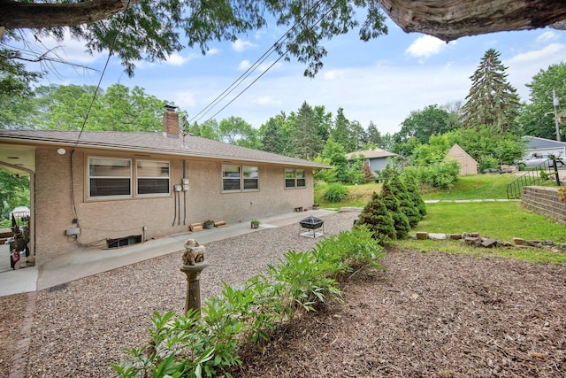 895 Humboldt Ave W, Saint Paul, MN 55118 - view of side of property featuring a chimney, a patio area, a yard, and stucco siding