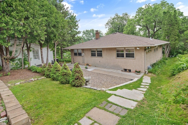 895 Humboldt Ave W, Saint Paul, MN 55118 - rear view of property featuring a chimney, a lawn, a patio area, stucco siding, and roof with shingles