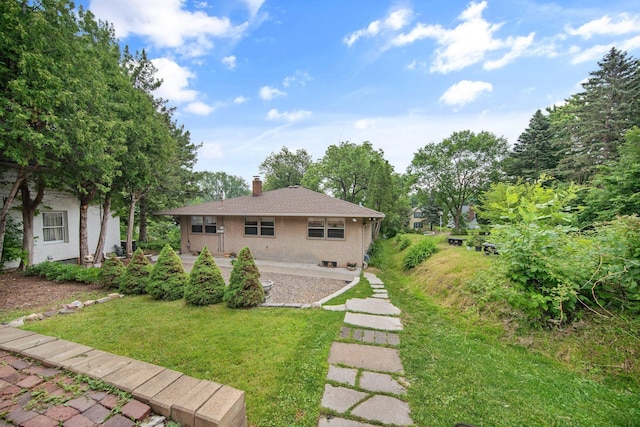 895 Humboldt Ave W, Saint Paul, MN 55118 - back of house with a chimney, a yard, and stucco siding