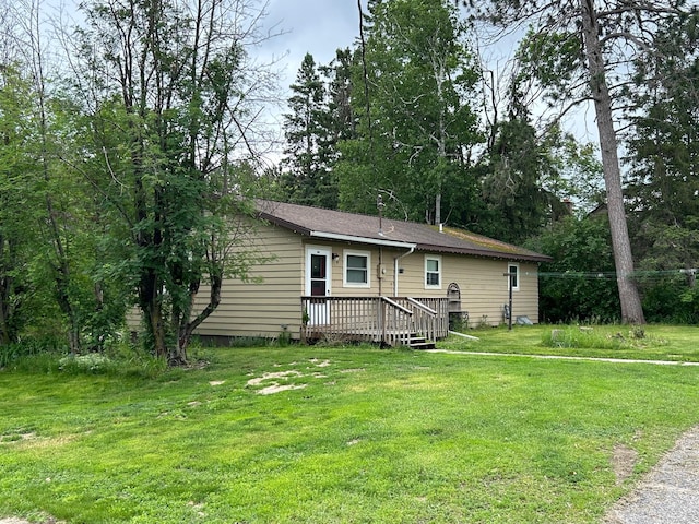 903 3rd Ave, Grand Rapids, MN 55744 - view of front of home with a wooden deck and a front yard