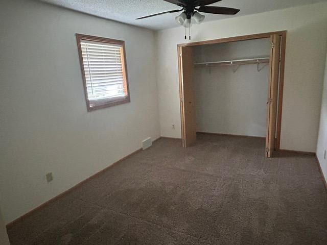 903 3rd Ave, Grand Rapids, MN 55744 - unfurnished bedroom with a closet, carpet, a ceiling fan, and a textured ceiling