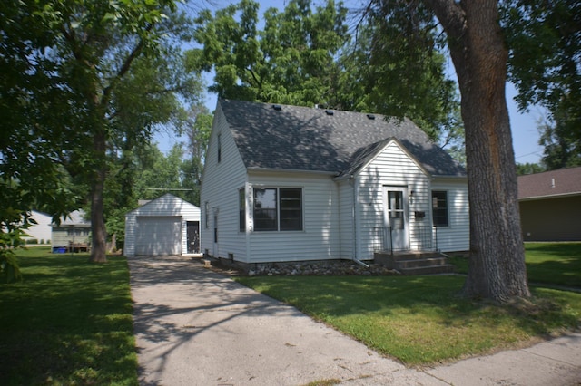 13 S St, Morris, MN 56267 - view of front of home with an outdoor structure, a detached garage, a shingled roof, and a front lawn