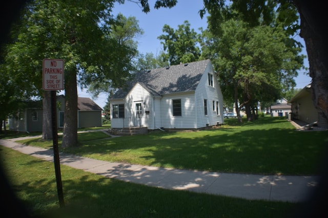 13 S St, Morris, MN 56267 - view of front facade with a front lawn, a shingled roof, and entry steps