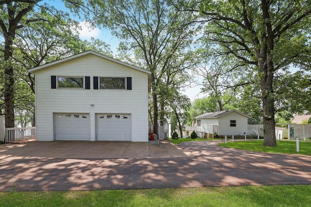10196 48th St, Clear Lake, MN 55319 - view of front facade with concrete driveway and a garage