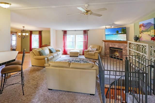 10196 48th St, Clear Lake, MN 55319 - carpeted living room featuring track lighting, a brick fireplace, a chandelier, and a ceiling fan