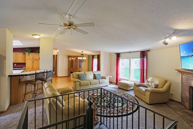 10196 48th St, Clear Lake, MN 55319 - living area with a ceiling fan, a brick fireplace, a chandelier, lofted ceiling, and rail lighting