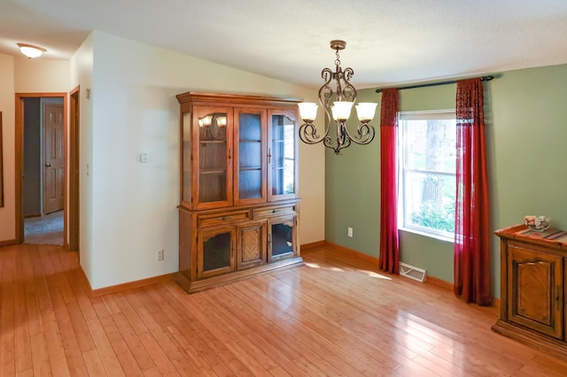 10196 48th St, Clear Lake, MN 55319 - unfurnished dining area featuring a chandelier and light wood-type flooring