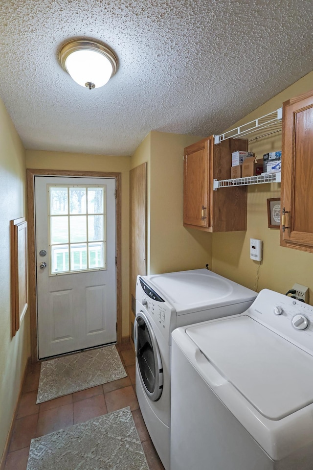 10196 48th St, Clear Lake, MN 55319 - washroom featuring cabinet space, independent washer and dryer, a textured ceiling, and tile patterned flooring