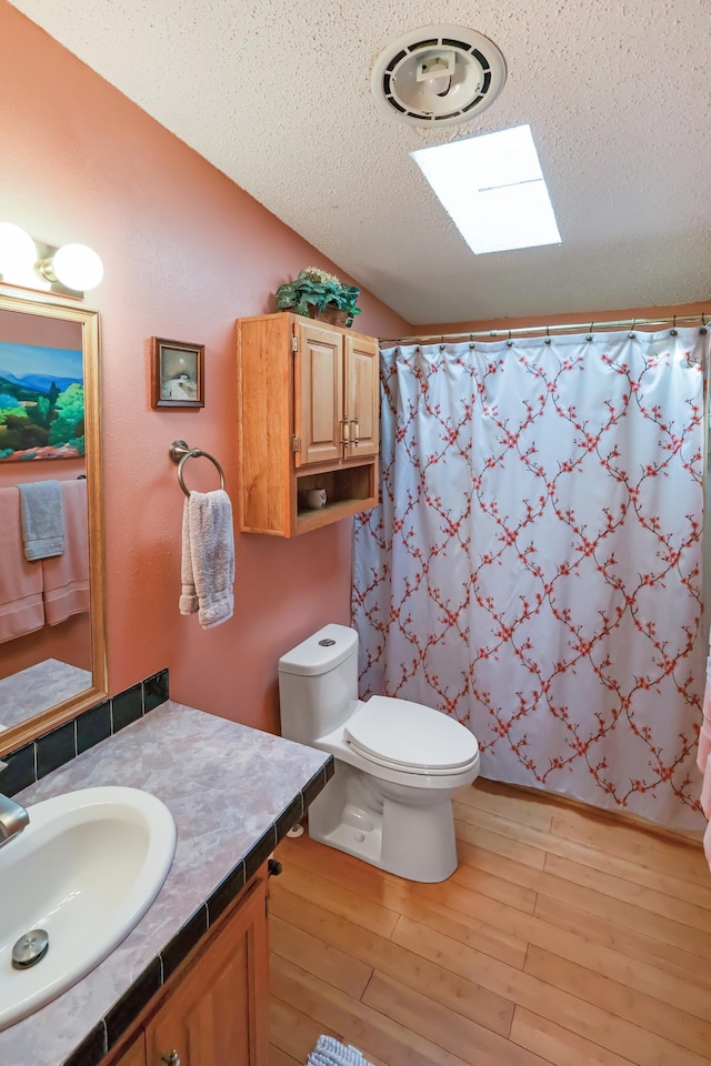 10196 48th St, Clear Lake, MN 55319 - bathroom featuring vanity, a textured ceiling, wood finished floors, vaulted ceiling, and curtained shower