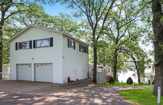 10196 48th St, Clear Lake, MN 55319 - view of property exterior with concrete driveway and a garage