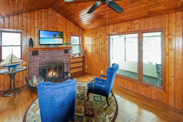 10196 48th St, Clear Lake, MN 55319 - living room with vaulted ceiling, plenty of natural light, wood finished floors, a brick fireplace, and wood walls