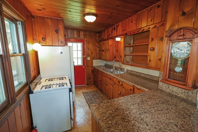 10196 48th St, Clear Lake, MN 55319 - kitchen featuring white appliances, open shelves, brown cabinets, wood ceiling, and wood walls