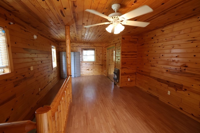 10196 48th St, Clear Lake, MN 55319 - unfurnished room with wood ceiling, wood walls, light wood-style floors, heating unit, and ceiling fan