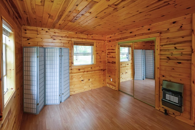 10196 48th St, Clear Lake, MN 55319 - unfurnished room with heating unit, wood finished floors, wood walls, and wood ceiling