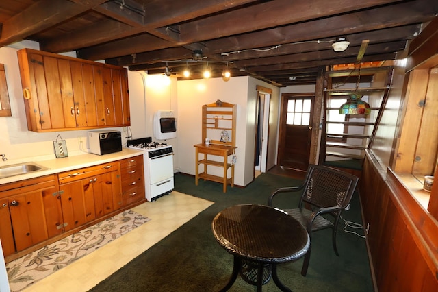 10196 48th St, Clear Lake, MN 55319 - kitchen with white gas range, brown cabinets, light countertops, and dark flooring