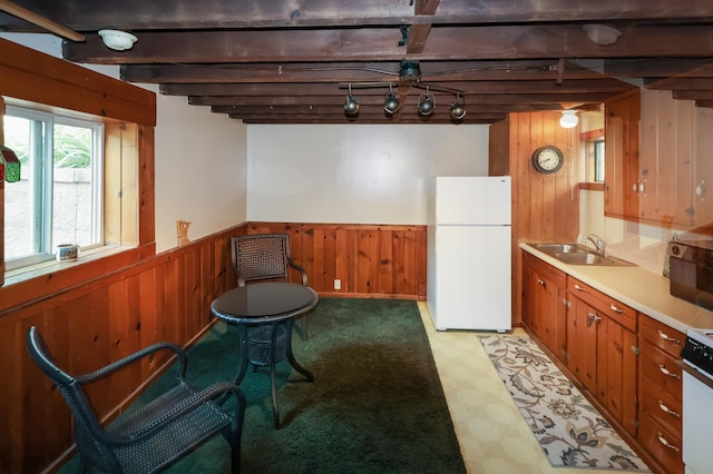10196 48th St, Clear Lake, MN 55319 - kitchen with freestanding refrigerator, wooden walls, brown cabinets, light flooring, and track lighting