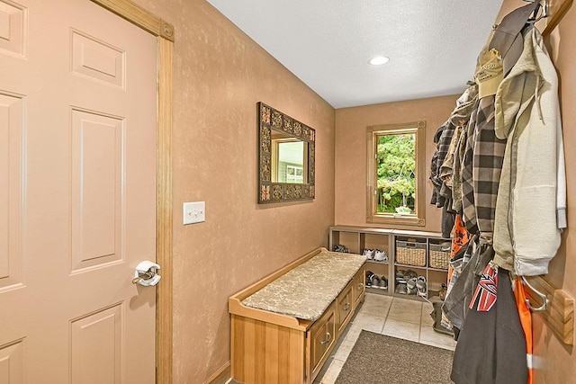 11672 147th Ave, Straight River Twp, MN 56464 - mudroom featuring a textured wall, a textured ceiling, light tile patterned floors, and recessed lighting