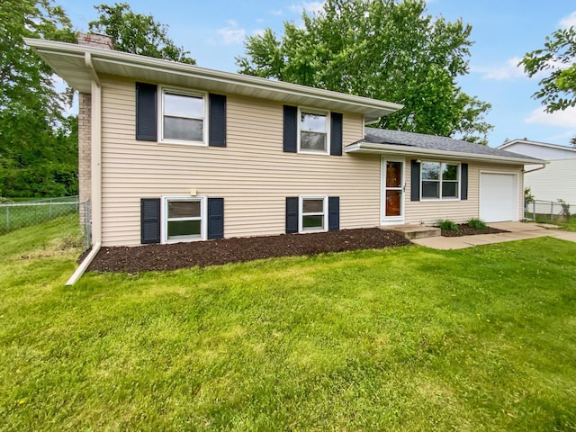 8337 80th St S, Cottage Grove, MN 55016 - split level home featuring a chimney, a garage, and driveway