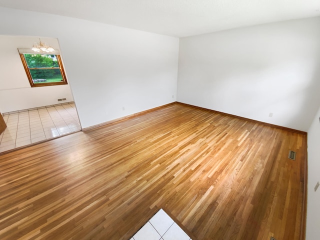 8337 80th St S, Cottage Grove, MN 55016 - spare room with a chandelier, wood finished floors, and baseboards