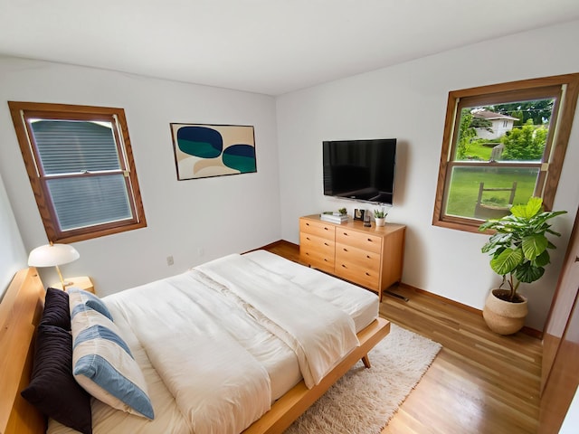 8337 80th St S, Cottage Grove, MN 55016 - bedroom featuring light wood-type flooring and baseboards