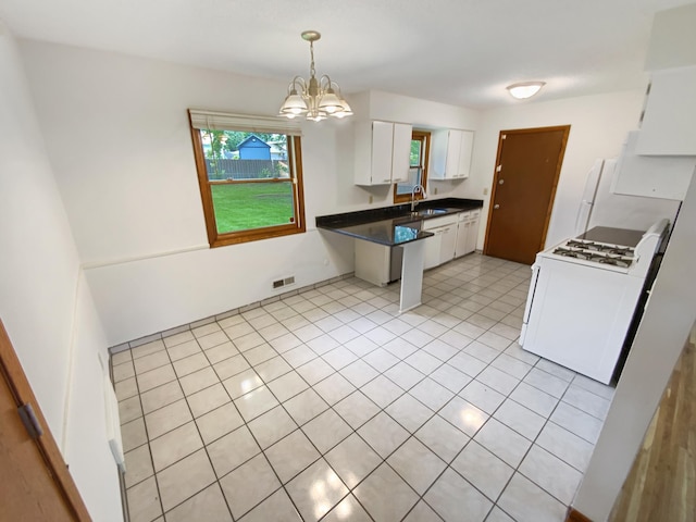 8337 80th St S, Cottage Grove, MN 55016 - kitchen with a sink, white gas range oven, white cabinetry, dark countertops, and a chandelier