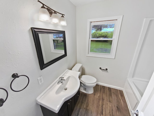 8337 80th St S, Cottage Grove, MN 55016 - full bathroom featuring vanity, wood finished floors, toilet, baseboards, and a bathtub