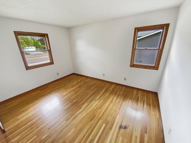 8337 80th St S, Cottage Grove, MN 55016 - spare room with light wood-type flooring and baseboards