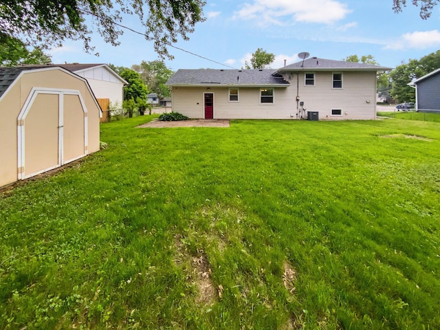8337 80th St S, Cottage Grove, MN 55016 - rear view of house with a lawn, a patio, and central AC