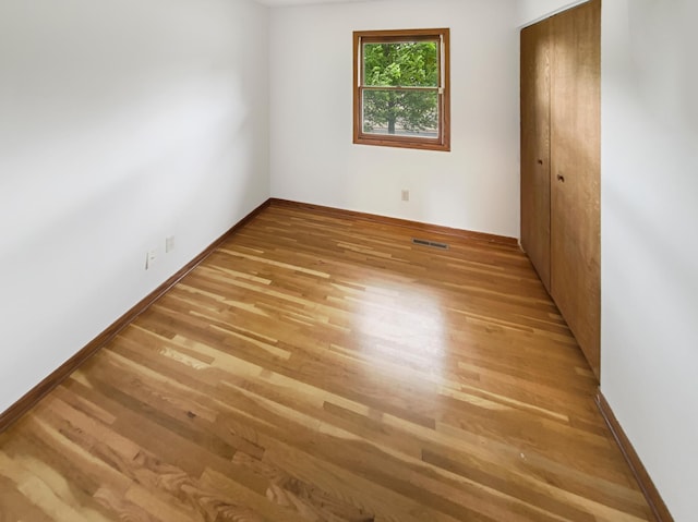 8337 80th St S, Cottage Grove, MN 55016 - unfurnished bedroom with wood finished floors, baseboards, and a closet