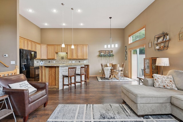 2936 18th Ave E, Shakopee, MN 55379 - living area with a towering ceiling, dark wood-style floors, a chandelier, and recessed lighting