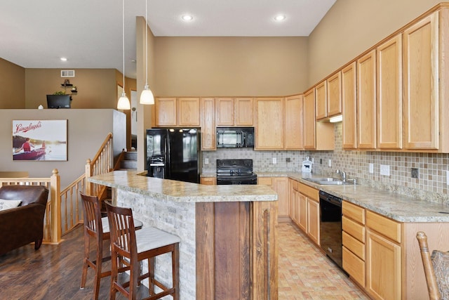 2936 18th Ave E, Shakopee, MN 55379 - kitchen featuring black appliances, light brown cabinetry, light countertops, backsplash, and recessed lighting