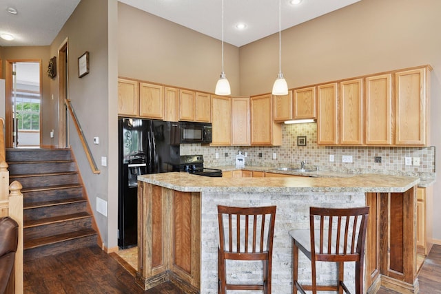2936 18th Ave E, Shakopee, MN 55379 - kitchen featuring light brown cabinets, black appliances, dark wood finished floors, light countertops, and a high ceiling