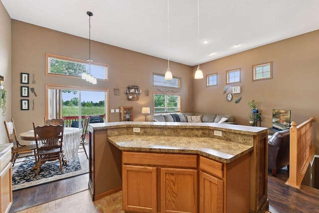 2936 18th Ave E, Shakopee, MN 55379 - kitchen featuring open floor plan, hanging light fixtures, a kitchen island, and brown cabinets