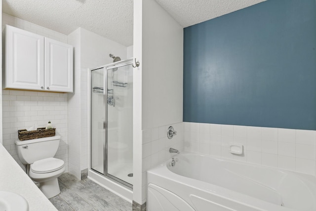 2936 18th Ave E, Shakopee, MN 55379 - full bath featuring a textured ceiling, a garden tub, a stall shower, wood finished floors, and vanity