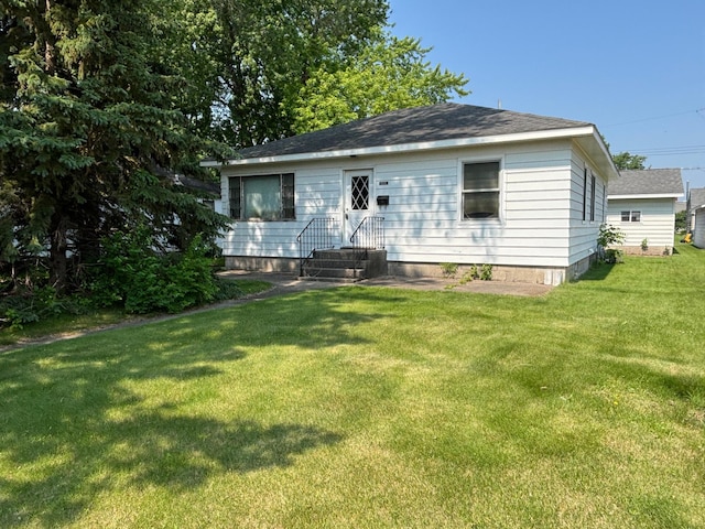 609 11th St N, Benson, MN 56215 - rear view of property featuring a lawn