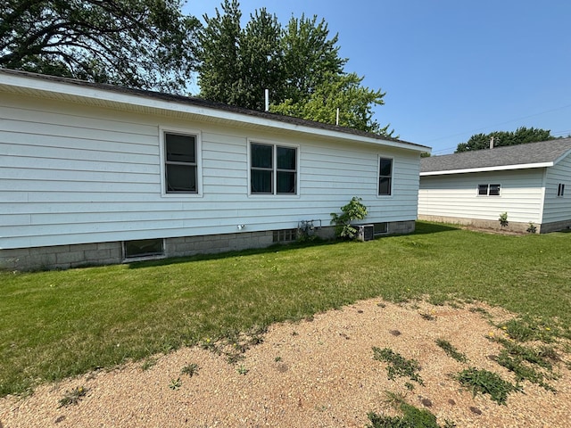 609 11th St N, Benson, MN 56215 - view of home's exterior featuring a lawn and a central AC unit