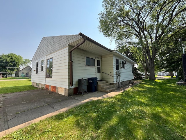 609 11th St N, Benson, MN 56215 - view of home's exterior featuring a lawn and entry steps