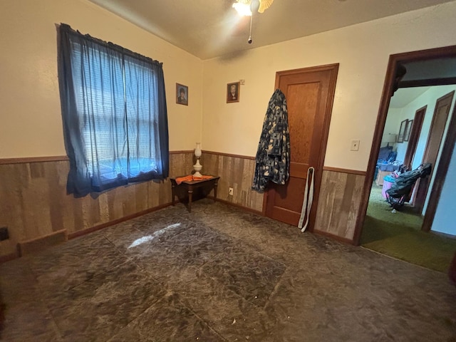 609 11th St N, Benson, MN 56215 - spare room with wainscoting, wood walls, and ceiling fan