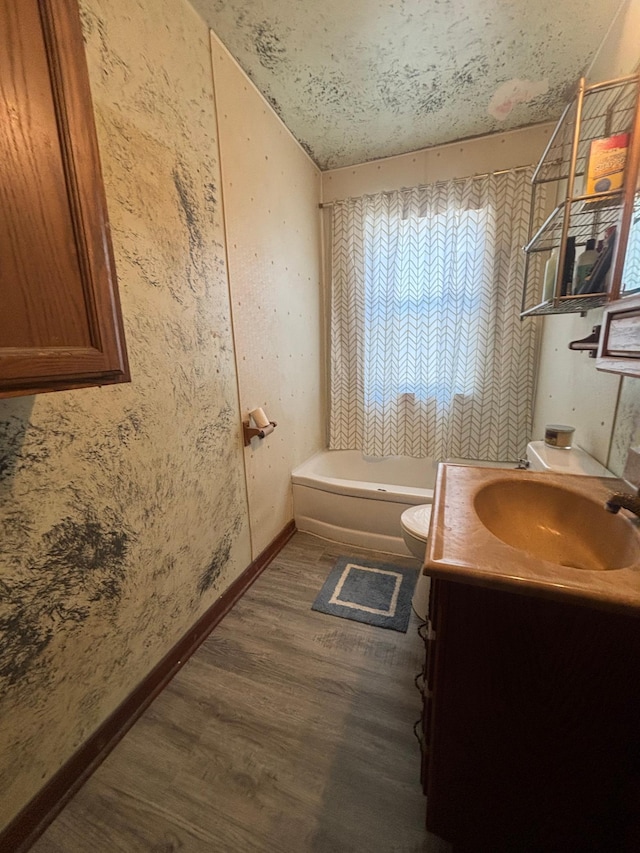 609 11th St N, Benson, MN 56215 - full bath featuring wood finished floors, vanity, a bath, and a shower