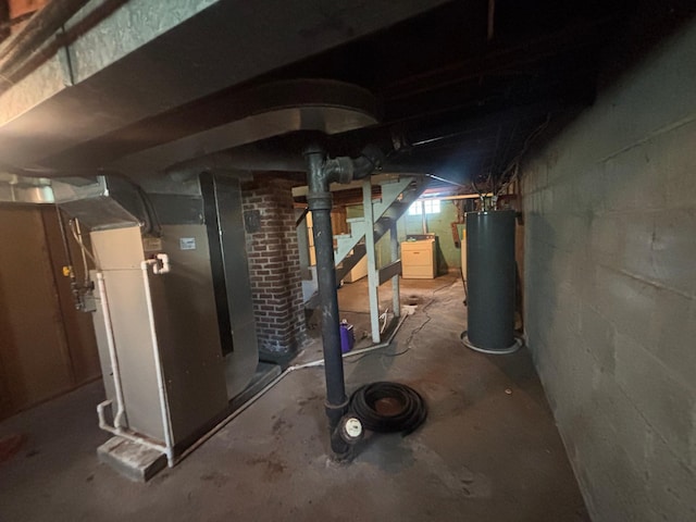 609 11th St N, Benson, MN 56215 - unfinished basement with water heater, heating unit, and stairway